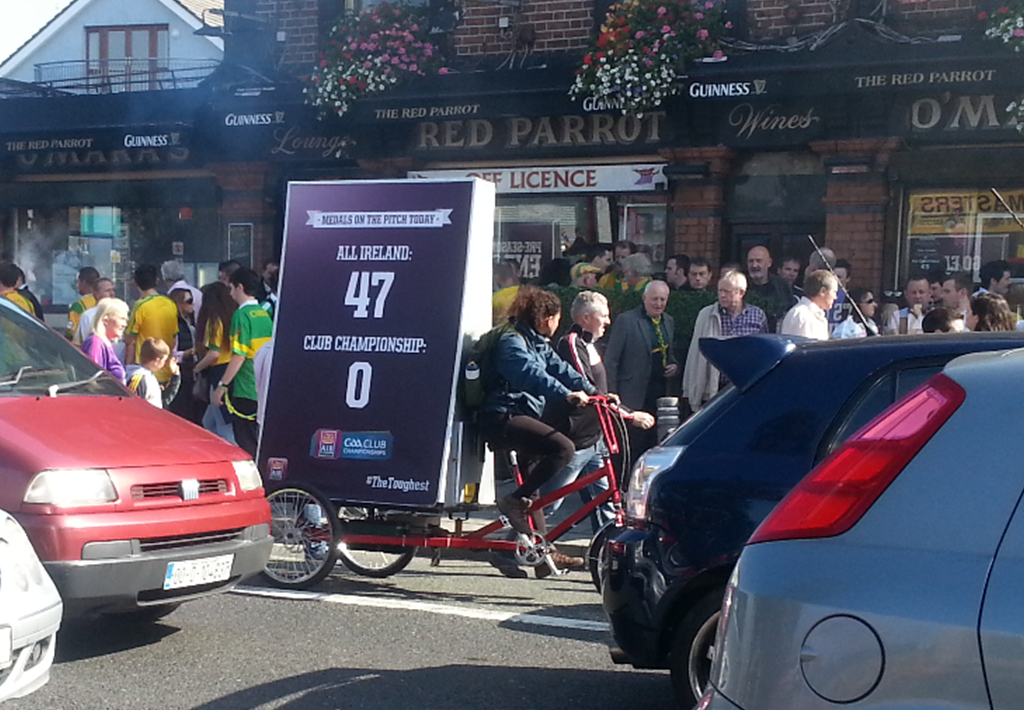 Electric advertising trike cycling past crowd in dublin, Adbikes Mobile Marketing Magic